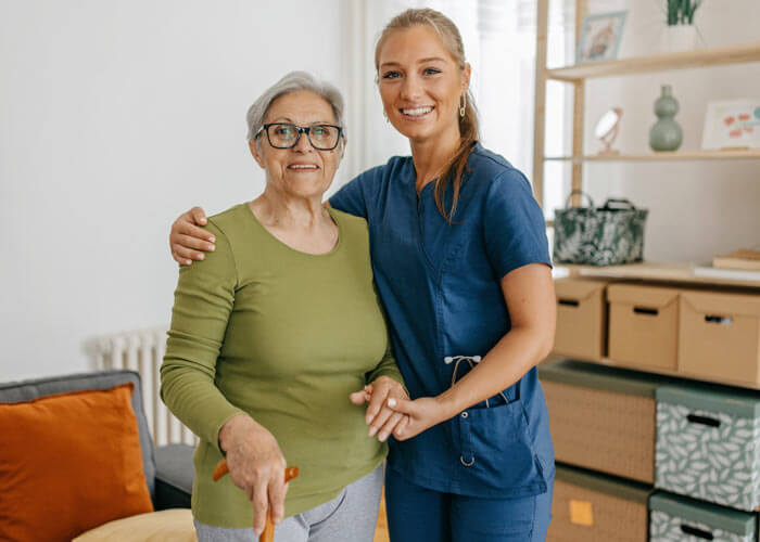Caregiver with client holding a cane