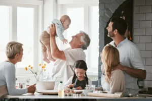A family who has embraced multigenerational living shares a happy moment together in the kitchen.