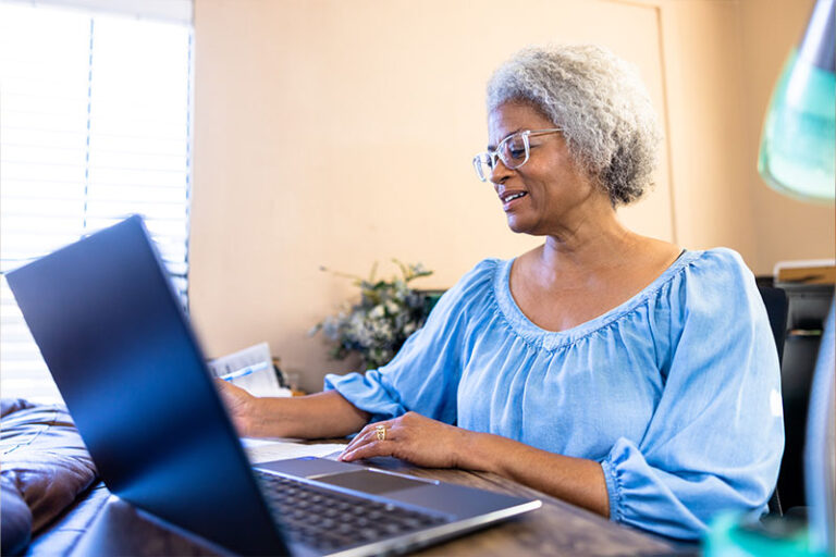 A woman reads an article online about why AI use among seniors is growing.
