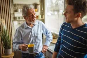A family caregiver uses caregiving conflict resolution techniques during a conversation with an older parent.