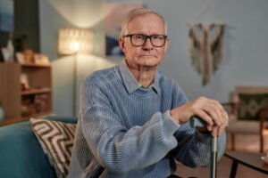A senior man frowns as he struggles to accept dementia care at home after being independent for so long.