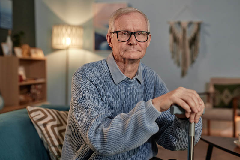 A senior man frowns as he struggles to accept dementia care at home after being independent for so long.